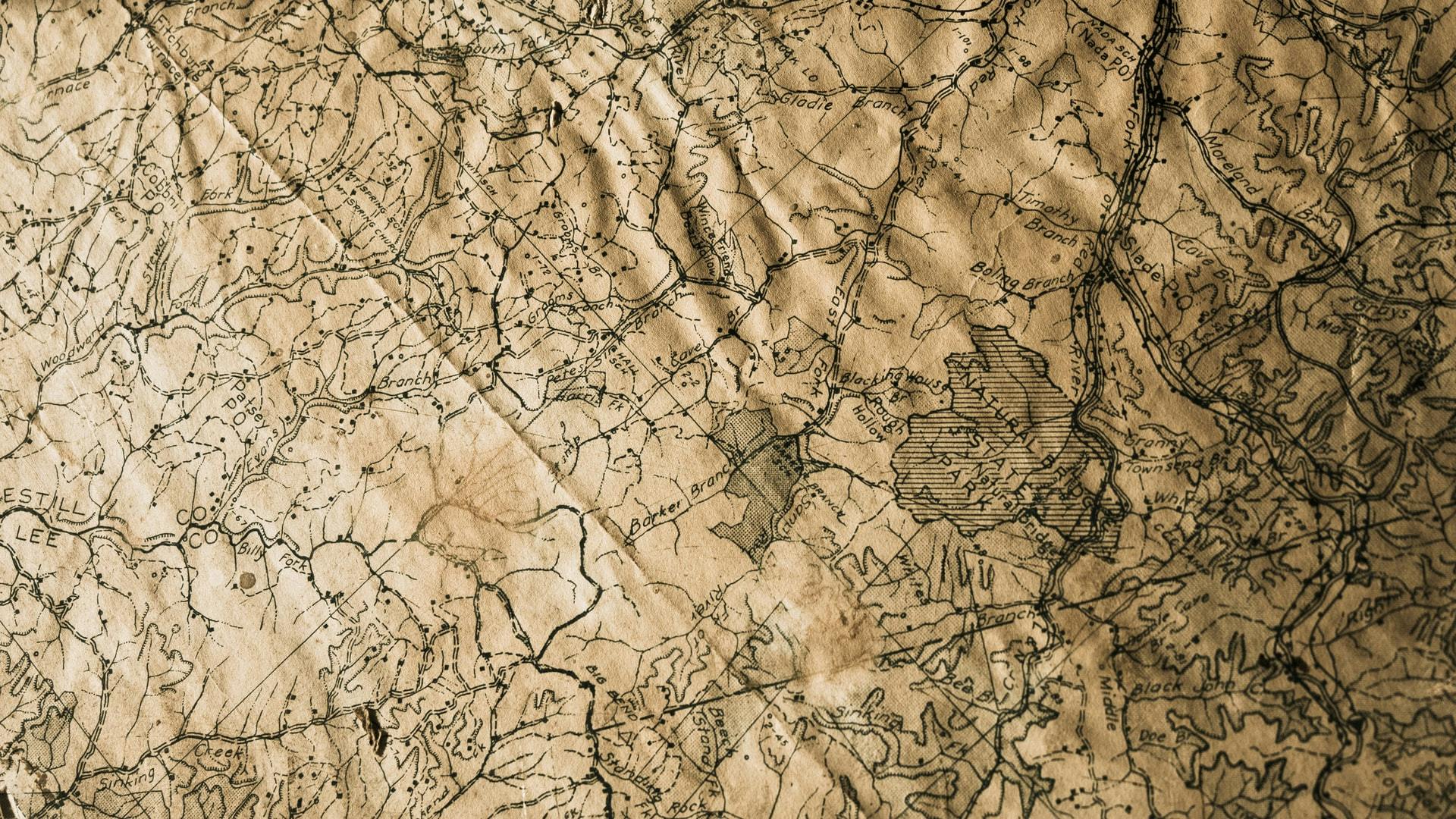 Photo of a crumpled map. By Nik Shuliahin on Unsplash